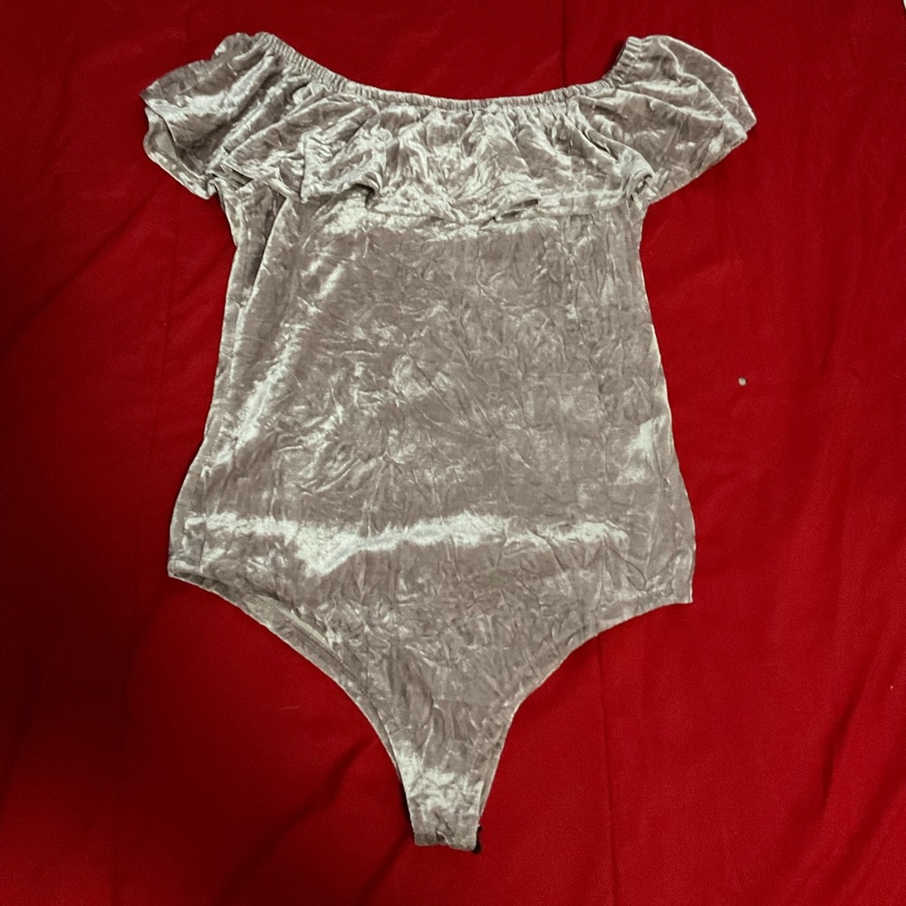 Purple metallic bodysuit with off the shoulder design and ruffles